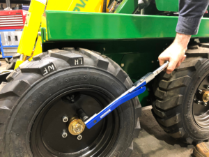 Checking tyre nut bolts on kanga mini Loader